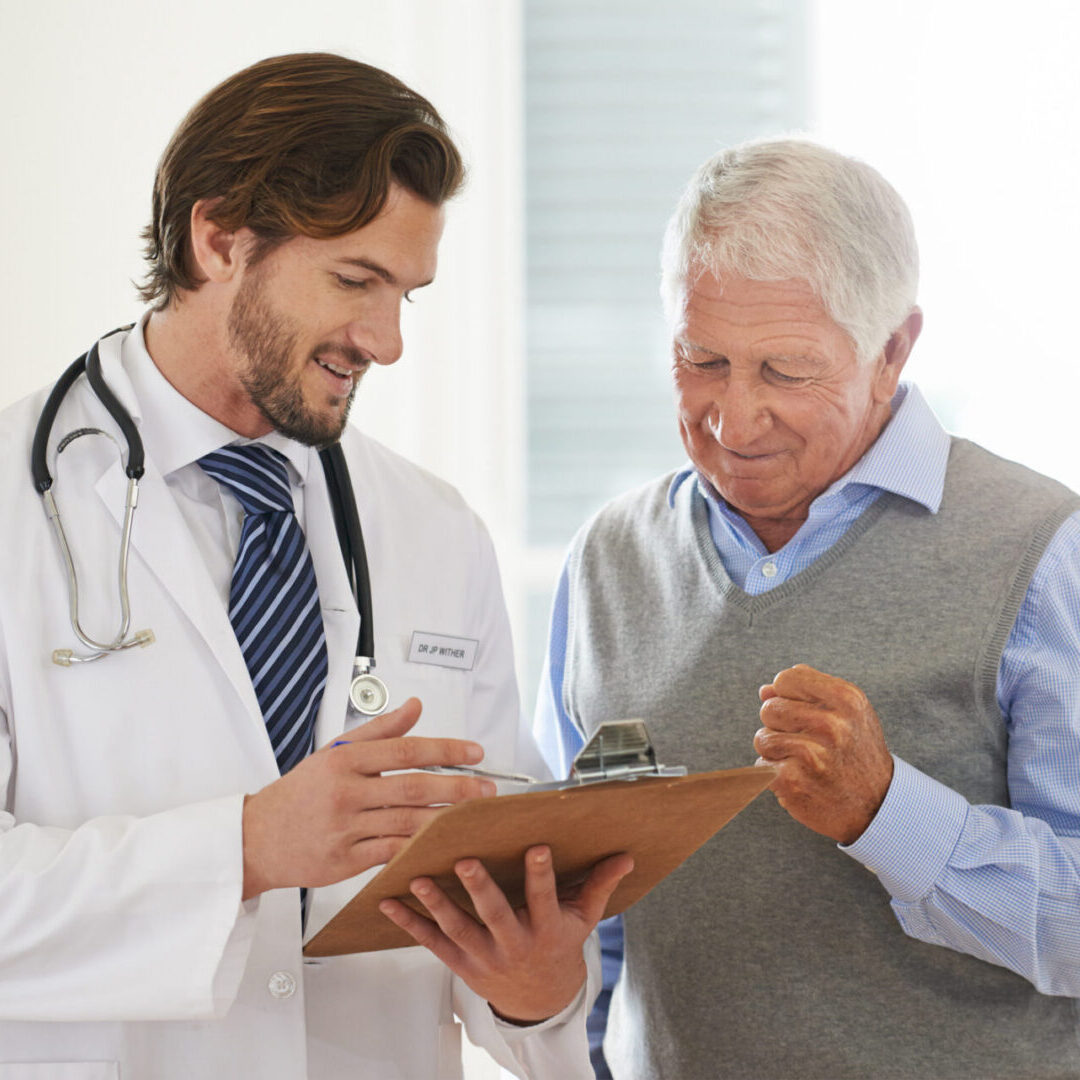 Medical consultation between doctor and older gentleman