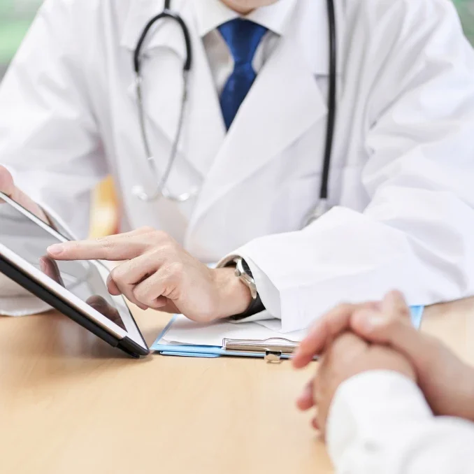 Doctor explaining results on tablet